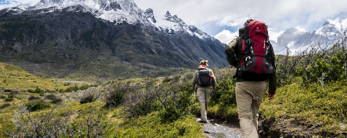 Hikers wearing outdoor apparel on a mountain trail